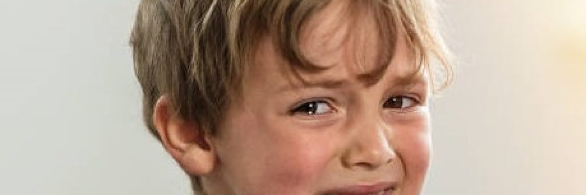 Caucasian Child boy crying looking at the camera